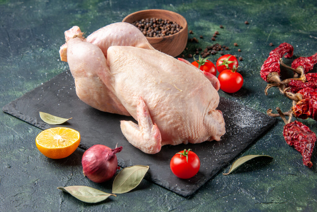 front view fresh raw chicken with tomatoes dark meal animal photo food color chicken kitchen meat